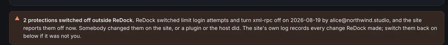 A warning strip on a site page reading two protections switched off outside ReDock, naming which two, when ReDock switched them on and who did it, and saying somebody changed them on the site, or a plugin or the host did, with an offer to switch them back on below.